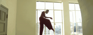 Dancer moving in front of a window