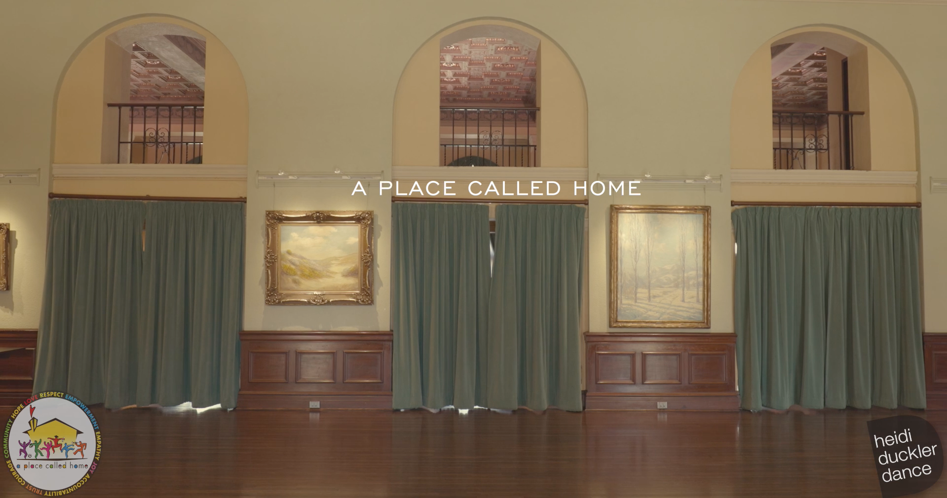 Empty ballroom with curtains over the doorways. Overlaying text reads "A Place Called Home." Logos for Heidi Duckler Dance and A Place Called Home are place in the bottom corners of the image
