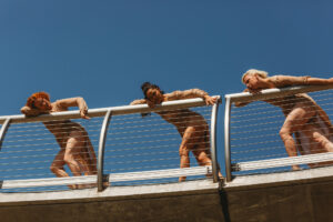 Women dancing on a bridge