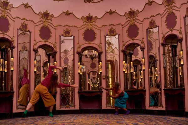 Dancers performing in a mirrored room